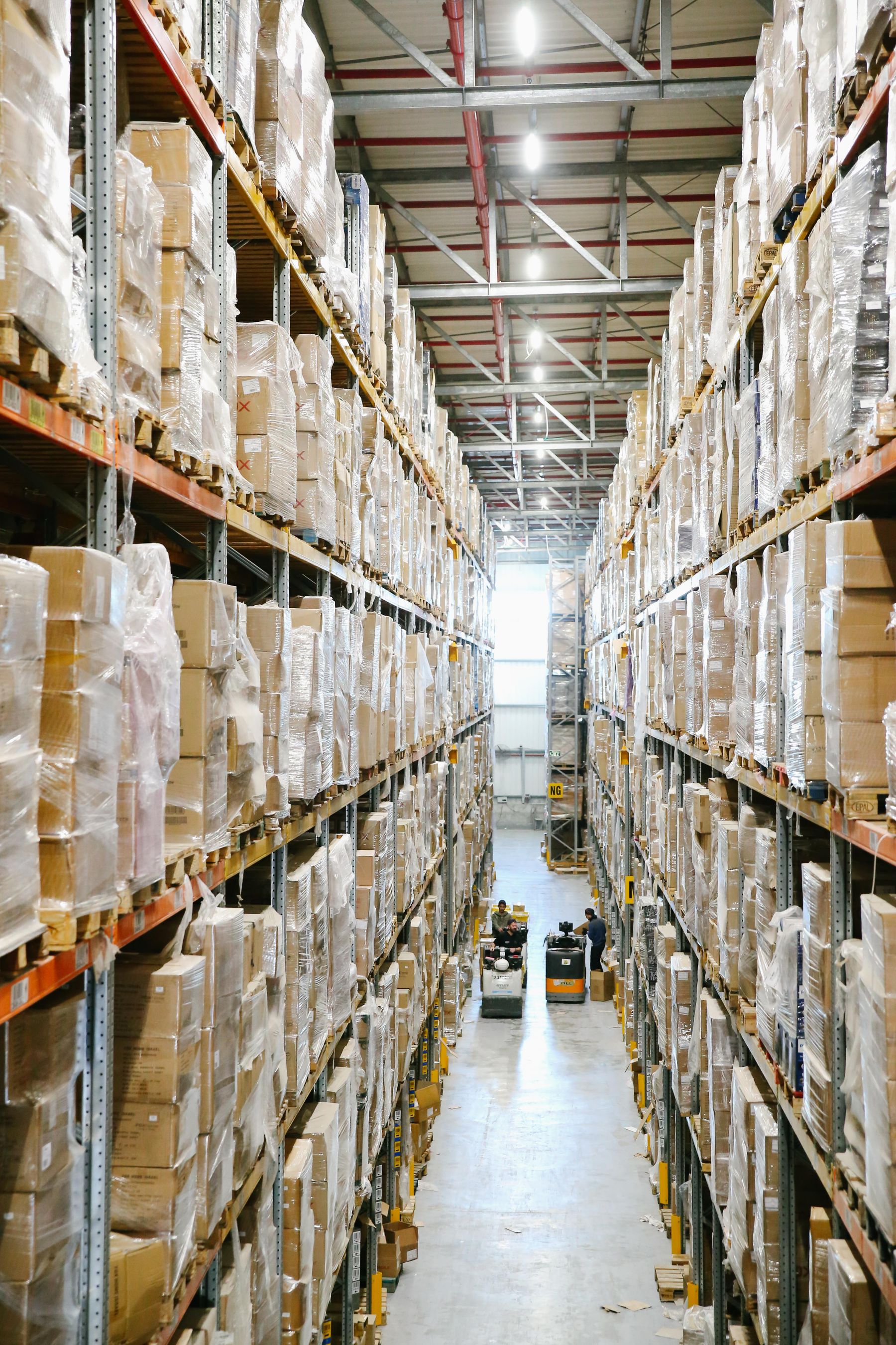 Warehouse aisles lined with inventory and shipping cartons