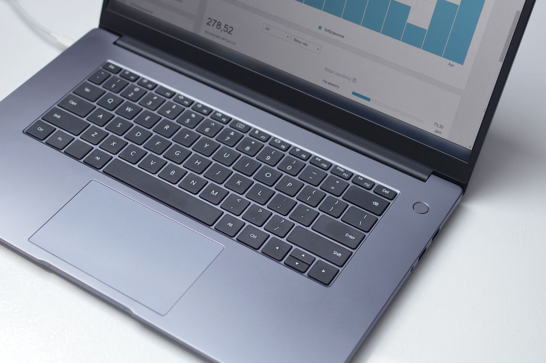 Laptop displaying a clean performance dashboard and bar chart