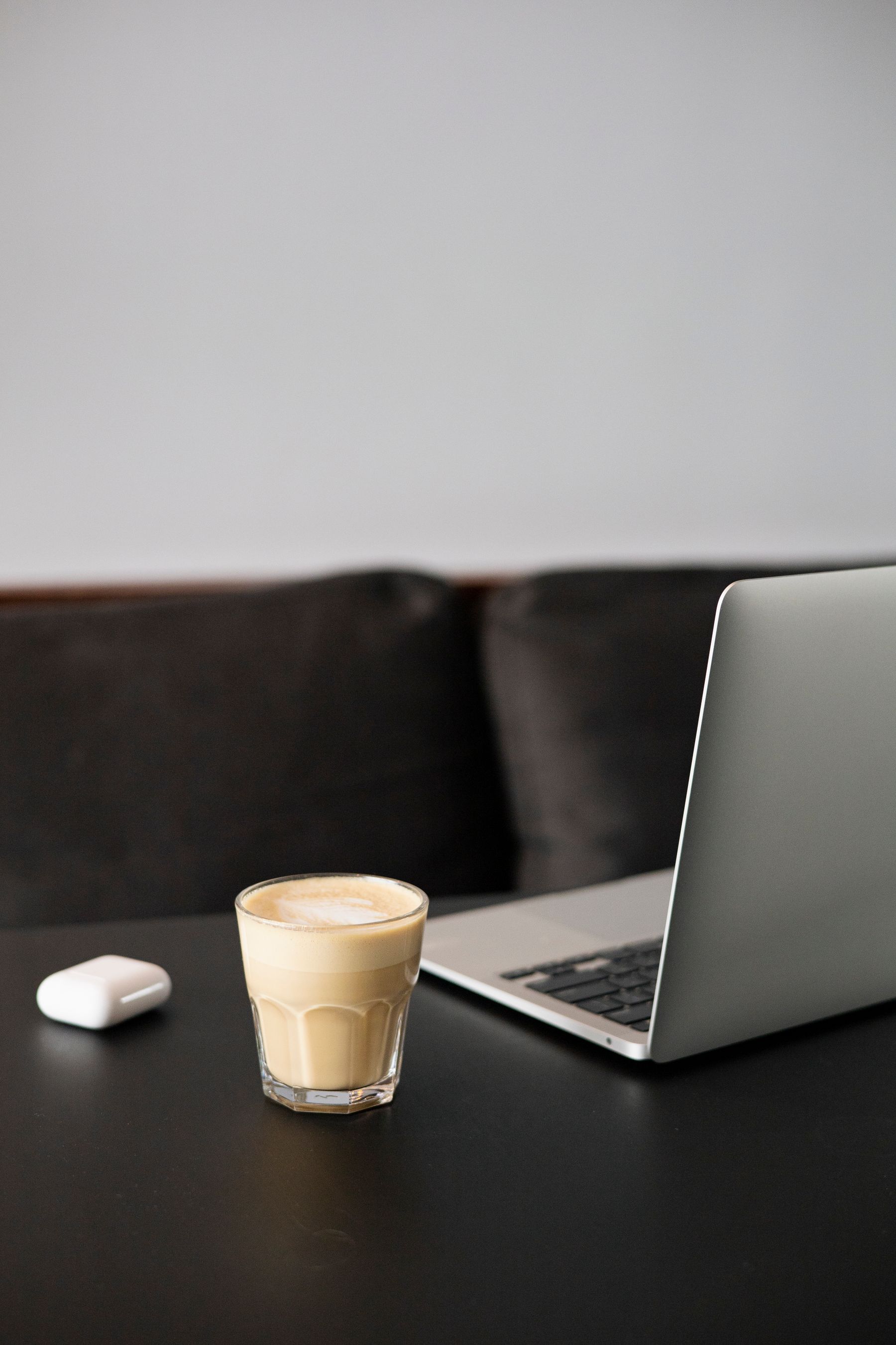Open laptop and coffee arranged on a clean worktable